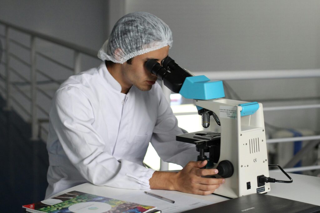 a scientist looking into a microscope Image
